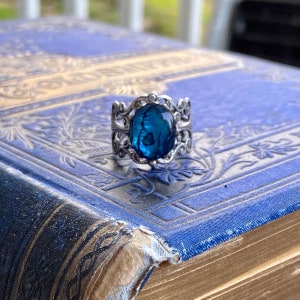 Antiqued silver filigree adjustable ring with blue shell.