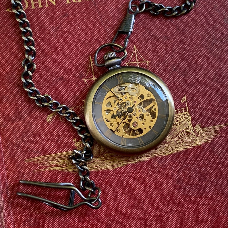 Men's pocket watch.  Brass time piece with glass front.