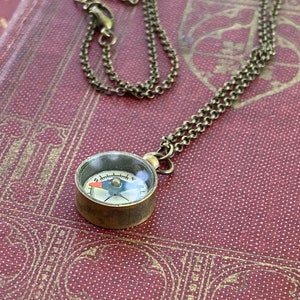 Antiqued brass working compass necklace. Makes a great gift for moving or graduation.