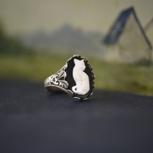 Antiqued silver vintage style adjustable ring with a black and white cat cameo.