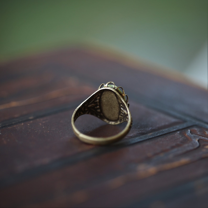 Adjustable antiqued brass vintage style ring showing back.