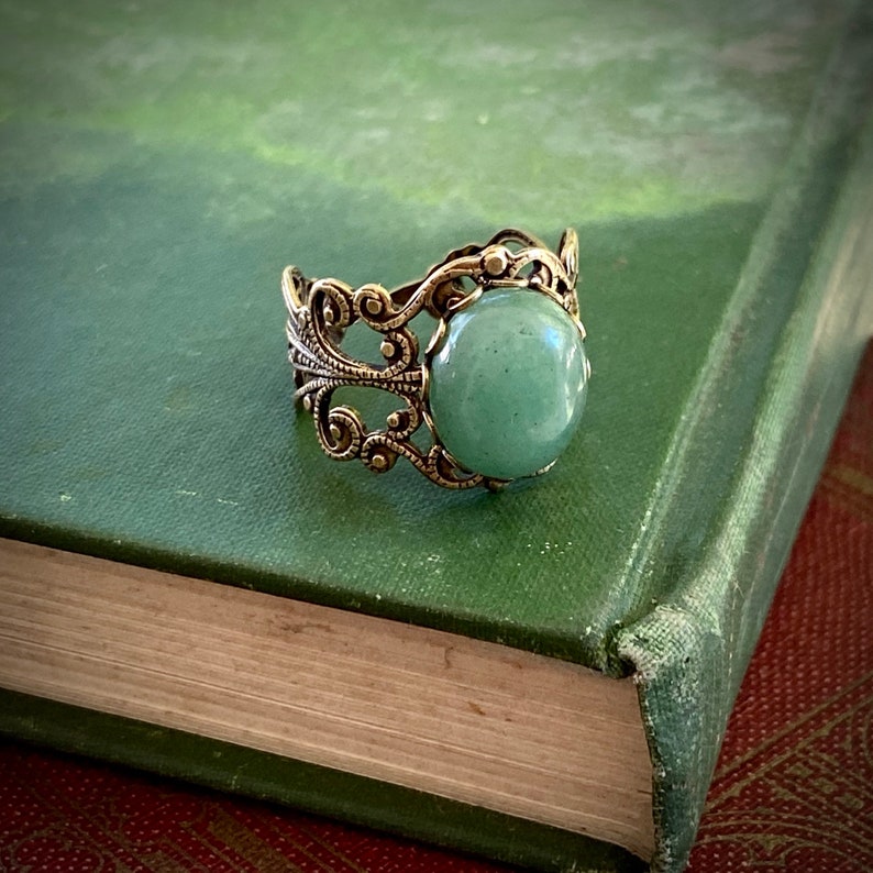 Sage green aventurine stone mineral cabochon on and antiqued brass adjustable filigree ring in vintage=style.