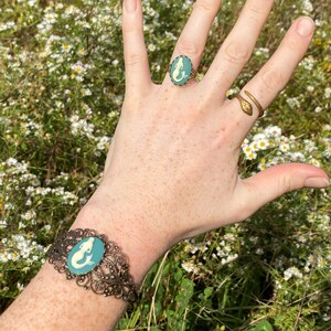 Antiqued brass adjustable vintage style ring with a blue and cream mermaid cameo with matching cuff bracelet.