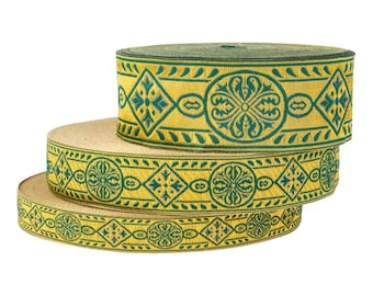 May include: Three spools of decorative ribbon with a repeating pattern of teal green floral and geometric designs on a golden yellow background. The ribbon is stacked, showing the detailed woven texture.