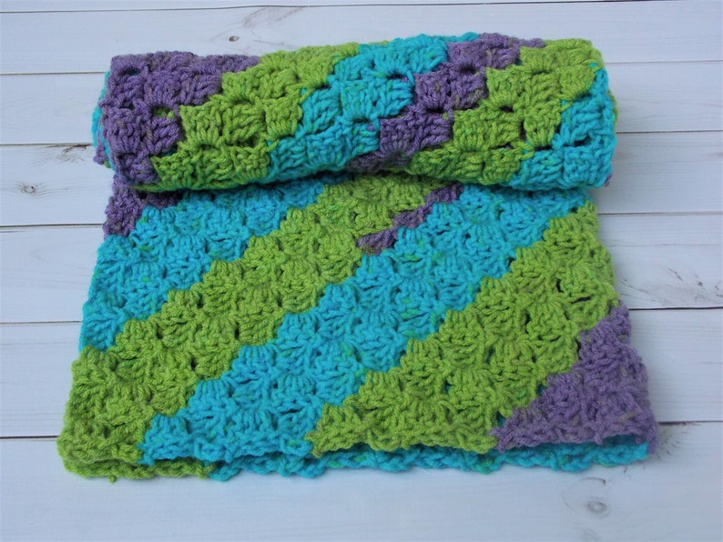 pram stroller car seat aqua crocheted diagonal stripe baby blanket afghan rug purple green multicolored stripes girl
