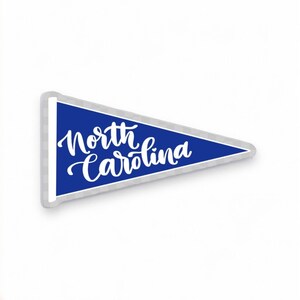 May include: A blue pennant with white lettering that reads "North Carolina".