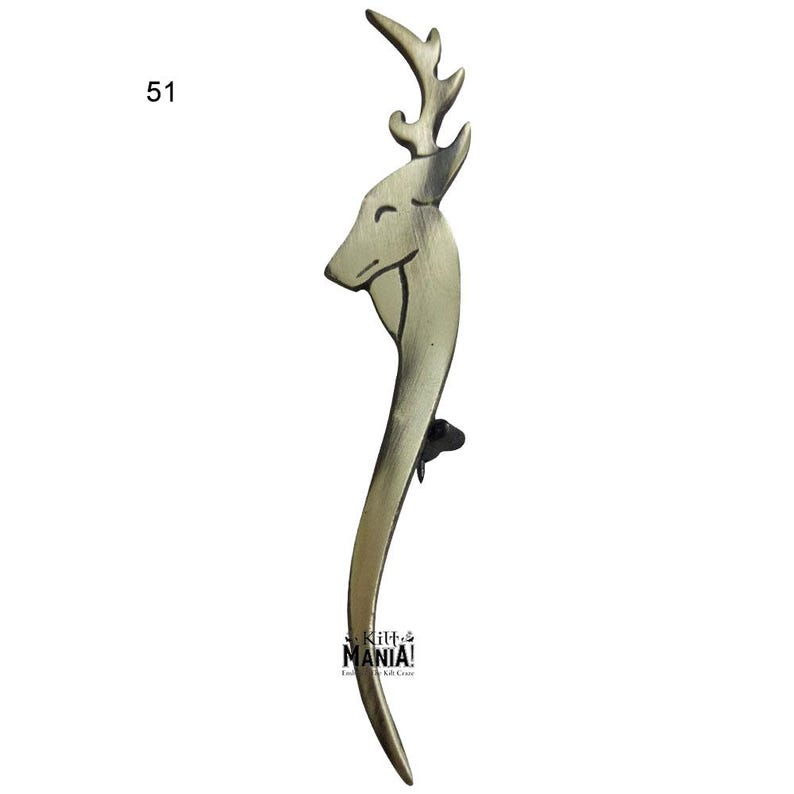 May include: A gold-toned metal door handle shaped like a deer head with antlers. The handle is curved and has a detailed design.