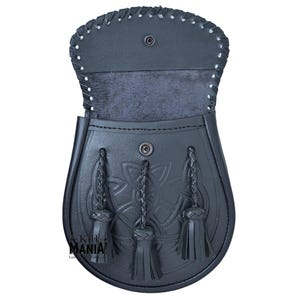 May include: Black leather kilt sporran with a Celtic knot design and three tassels. The sporran has a flap that opens to reveal a soft lining.