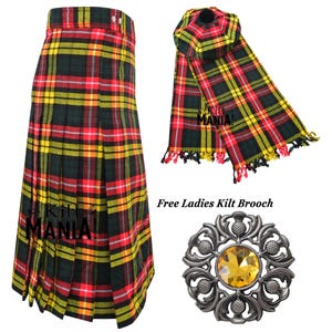 May include: A red, yellow, and green plaid kilt with a matching plaid scarf and a silver kilt brooch with a yellow gem. The text "Kilt Mania!" is visible on the scarf and kilt.