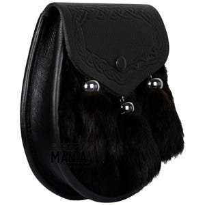 May include: Black leather sporran with a Celtic knot design and three black fur tassels.