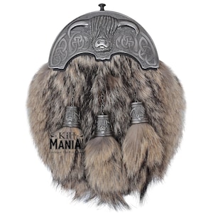 May include: A brown and grey fur sporran with a silver metal embellishment featuring a Highland cow head and Celtic knotwork. The sporran has three tassels with silver metal caps.