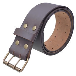 May include: A rolled-up brown leather belt with a double-prong buckle and brass rivets. The belt has multiple holes for adjustment and is made of thick, durable leather. The buckle and rivets are a contrasting gold color.