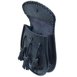 May include: Black leather kilt pouch with a Celtic knot design and a flap closure. The pouch has three tassels and a black lining.