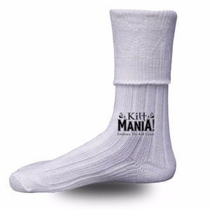 May include: White ribbed socks with a fold-over top. The socks have a black logo that says "Kilt Mania! Embrace The Kilt Craze."