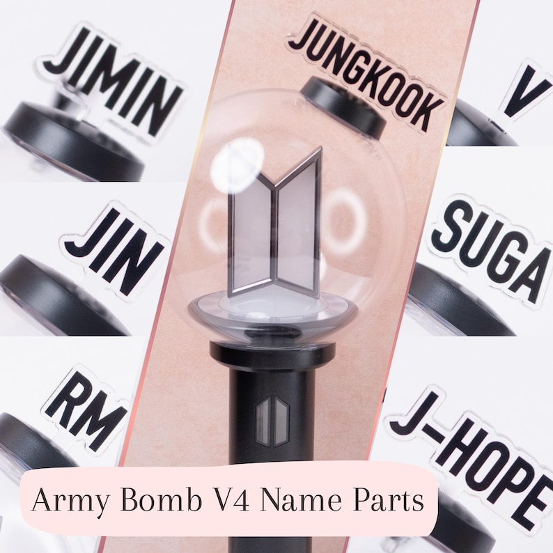 May include: A collection of clear acrylic name inserts for an Army Bomb V4 light stick, featuring the names JIMIN, JUNGKOOK, V, JIN, SUGA, RM, and J-HOPE in bold black lettering. The center shows a black light stick with a clear globe top.
