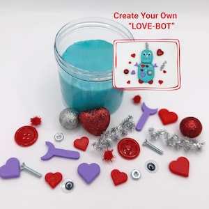 Peut inclure: Un pot de matériau bleu avec diverses fournitures d'artisanat. Comprend des cœurs rouges et violets, des boutons, des yeux globuleux et un dessin d'un robot bleu avec le texte "Create Your Own LOVE-BOT".