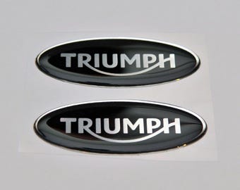 2 pegatinas TRIUM de 65 x 25 mm. Logotipo 3D abovedado.