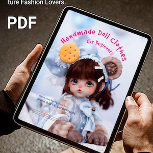 May include: A tablet displays a PDF sewing guide for doll clothes. The guide features a doll in a blue outfit with a cookie-shaped accessory. Text on the tablet reads "Handmade Doll Clothes for Beginners" and "Create Adorable Doll Outfits with Ease."