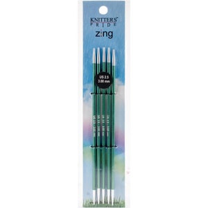 May include: A set of five green knitting needles with silver tips. The needles are packaged in a clear plastic sleeve with the brand name "Knitters Pride" and the product name "zing" printed on the front. The needles are labeled "US 2.5 - 3.00 mm".
