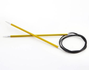 May include: A pair of gold-colored circular knitting needles with black cord.