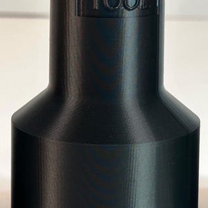 May include: Black plastic adapter with the text "1-1/2 TOOL" and "2-1/2 WAND" printed on it.