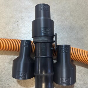 May include: Three black plastic vacuum cleaner attachments with the text "2-1/2" and "TOOL" printed on them. The attachments are designed to fit a 2-1/2 inch vacuum hose.