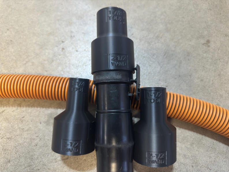 May include: Three black plastic vacuum cleaner attachments with the text "2-1/2" and "TOOL" printed on them. The attachments are designed to fit a 2-1/2 inch vacuum hose.