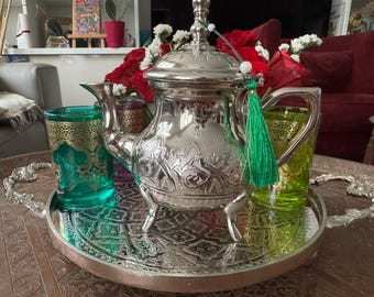 Moroccan tea set handcrafted in Fez, Morocco, including a teapot in the traditional Moroccan style, a tray, and colored glasses.