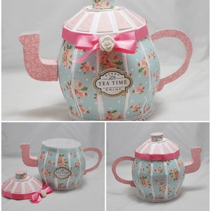 May include: A blue and pink paper teapot with a floral pattern and a white label that says "Steep stir Tea Time Enjoy". The teapot is a 3D paper craft.