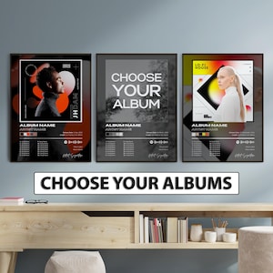 May include: Three rectangular wall posters featuring album cover designs. The left poster shows a person in profile with orange and black gradients. The center poster displays the text CHOOSE YOUR ALBUM. The right poster features a person with a yellow and black geometric background. Each includes tracklists and artist details.
