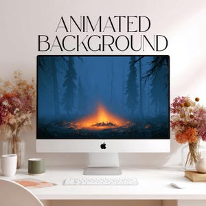 May include: A silver desktop computer monitor displaying an animated background of a glowing campfire in a dark forest. The text "ANIMATED BACKGROUND" is printed above the screen. A white keyboard and mouse sit on the desk below the monitor.