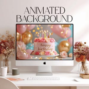 May include: A computer monitor displaying a pink birthday cake with lit candles and the text 'happy birthday' on the screen. Above the monitor, the text 'ANIMATED BACKGROUND' is visible. The setup includes a keyboard and dried flowers.