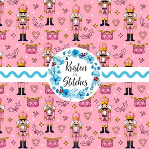 May include: A pink background with a repeating pattern of pink nutcrackers, drums, crowns, stars, holly, and candy hearts. A circular logo with blue flowers and the text "Kristen in Stitches" is in the center.