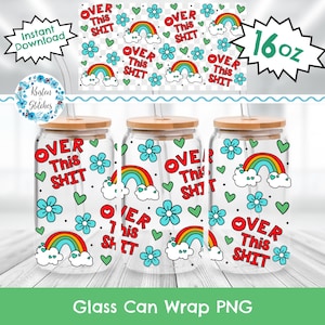 May include: Three glass can wraps with a rainbow, flower, and heart pattern. The text "OVER THIS SHIT" is in red. Each glass is 16 oz. and has a wooden lid and straw.
