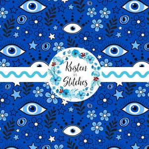 May include: A blue fabric pattern featuring stylized blue eyes, flowers, stars, and floral elements. The design includes a white circle with the text "Kristen in Stitches" surrounded by blue flowers. A wavy blue stripe accents the design.