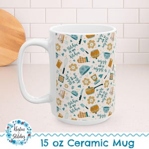 May include: White 15 oz ceramic mug with a repeating pattern of kitchen utensils, flowers, and the phrase "No Bitchin' in my Kitchen" in teal and gold. The mug has a large handle and is labeled "15 oz Ceramic Mug".