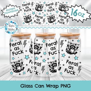 May include: Three clear glass can wraps with wooden lids, each featuring a raccoon illustration, stars, and the text "Feral as Fuck." The design includes lightning bolts and is a 16 oz size.
