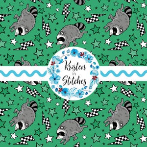 May include: A green fabric pattern featuring cartoon raccoons, black and white checkered lightning bolts, and white stars. A central circular white label displays a blue floral wreath surrounding the text Kristen in Stitches.