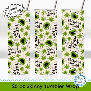 May include: A 20 oz skinny tumbler wrap featuring a repeating pattern of green cannabis leaves, a green monster character, and the words "DOOBIE MONSTER". The background is a light beige color. Includes a straw.