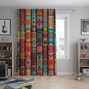 May include: A floor-length curtain featuring a vibrant patchwork design of repeating geometric and floral patterns in shades of orange, teal, pink, and yellow. The fabric hangs from a wooden rod, displaying a dense, colourful grid of motifs.