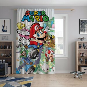 May include: A window curtain featuring a colorful Super Mario graphic print. The design displays Mario, Luigi, Princess Peach, Toad, and Bowser against a light green background with floating blocks and projectiles, all under the Super Mario logo.