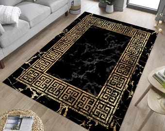 May include: Black and gold area rug with a marble pattern and a geometric border.