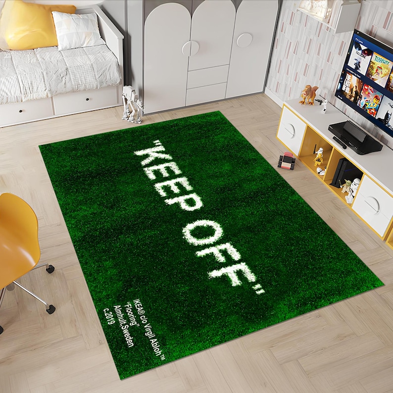 May include: Green rug with the text "KEEP OFF" in white lettering. The rug is made to look like grass. The text "IKEA&reg; clo Virgil Abloh&trade;" is in the bottom left corner of the rug.