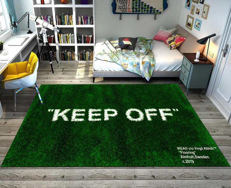 May include: A green shag rug with the text "KEEP OFF" in white lettering. The rug has a white label with the text "IKEA&reg; c/o Virgil Abloh&trade; "Flooring" Almhult, Sweden c.2019"