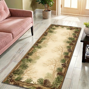 May include: A rectangular area rug with a nature-inspired design. The rug features a light beige center with a border of pine needles, pine cones, and tree branches. The rug is placed on a light wood floor, near a pink sofa.