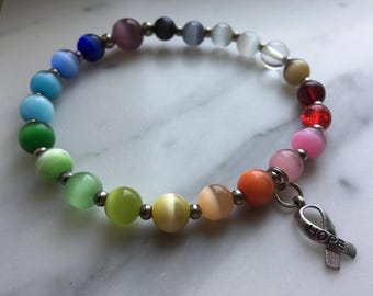 8-in. Rainbow Hope Bracelet Cat's Eye Beaded Cancer Awareness jewelry with focal purple bead & ribbon charm- 100% donation
