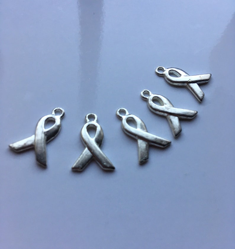 Destash Silvery cancer awareness ribbon charms 100% donation to cancer research image 1