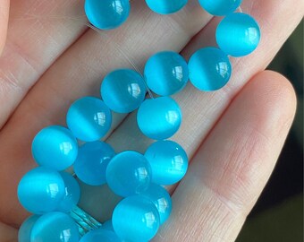 DESTASH - 8mm glowy aqua blue 7 3/4” strand fiberoptic catseye bead lot (22 beads)