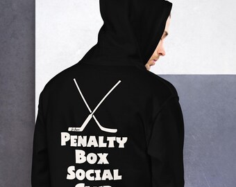 May include: Black hooded sweatshirt with a white graphic of two crossed hockey sticks and the text "Penalty Box Social Club".