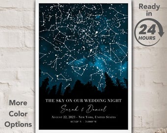 May include: A personalized star map print with a dark blue night sky background, white stars, and a forest silhouette. The text reads "The Sky on Our Wedding Night Sarah & Daniel August 22, 2023 - New York, United States 40.7128 N - 74.0060 W".